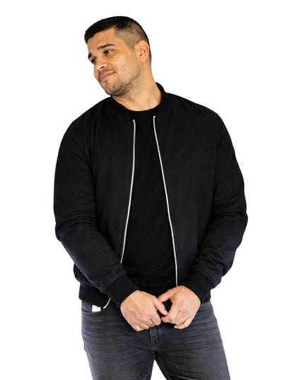 Man wearing a black bomber jacket on a white background