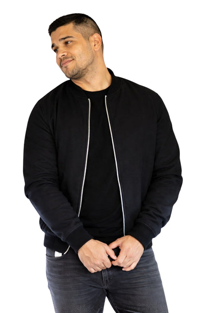 Man wearing a black bomber jacket on a white background