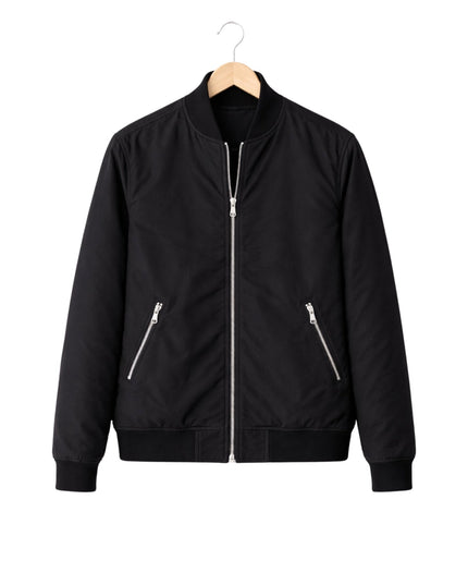 Black bomber jacket on a hanger against a white background