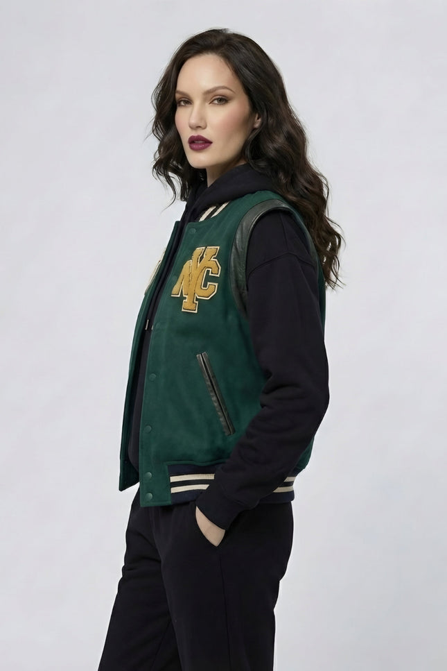 Woman wearing a green and black varsity jacket with a logo on a white background