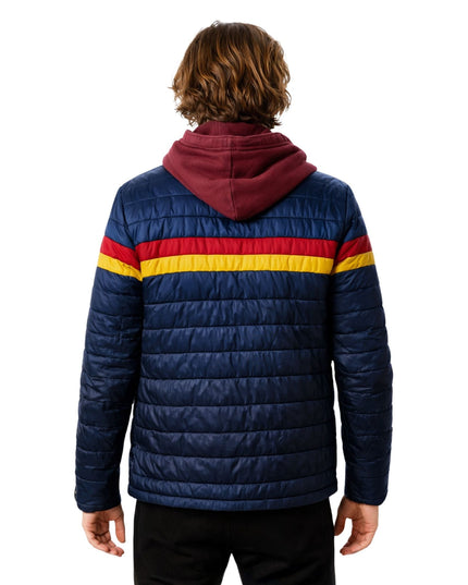 Person wearing a blue puffer jacket with red and yellow stripes on a white background