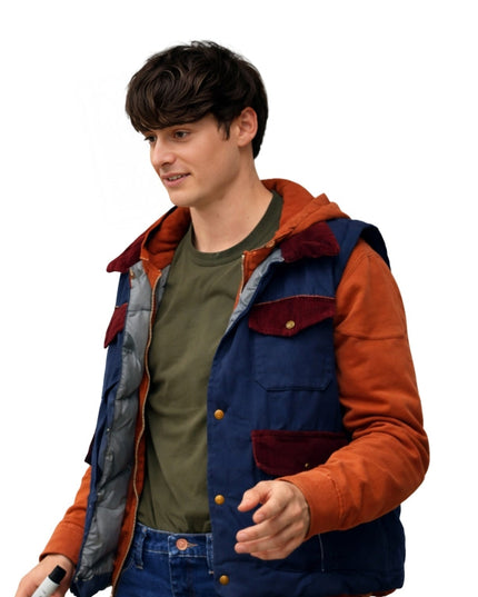 Person wearing a colorful jacket with orange and blue accents on a white background