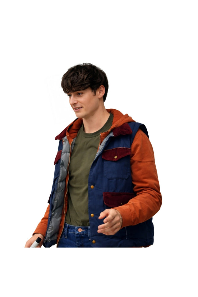 Person wearing a colorful jacket with orange and blue accents on a white background