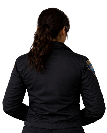 Person wearing a black jacket with a visible patch on the back