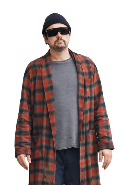 Man wearing a red and black plaid coat over a gray shirt on a white background