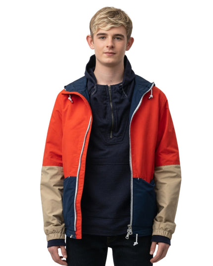 Person wearing a colorful jacket with red, blue, and beige sections on a white background