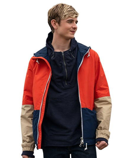 Person wearing a colorful jacket with red, blue, and beige sections on a white background