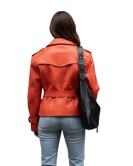 Person wearing an orange leather jacket and light blue jeans with a black bag on a white background