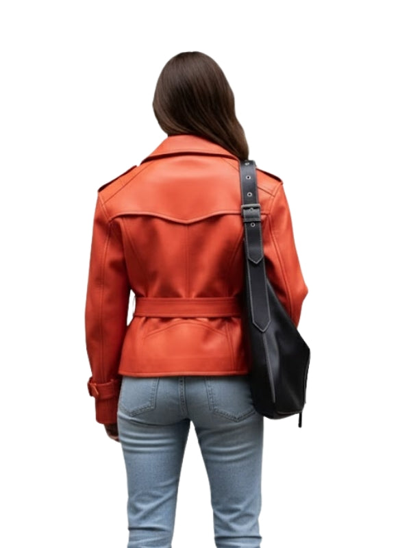 Person wearing an orange leather jacket and light blue jeans with a black bag on a white background