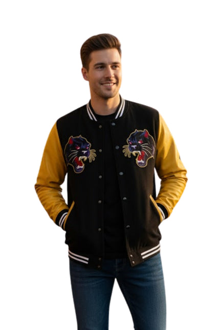 Man wearing a black and yellow varsity jacket with panther logos on a white background