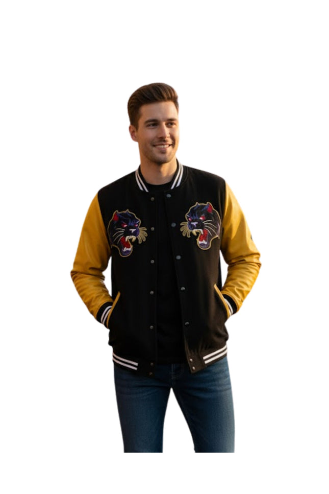 Man wearing a black and yellow varsity jacket with panther logos on a white background
