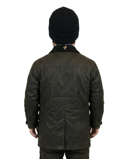 Person wearing a dark green jacket and black beanie on a white background
