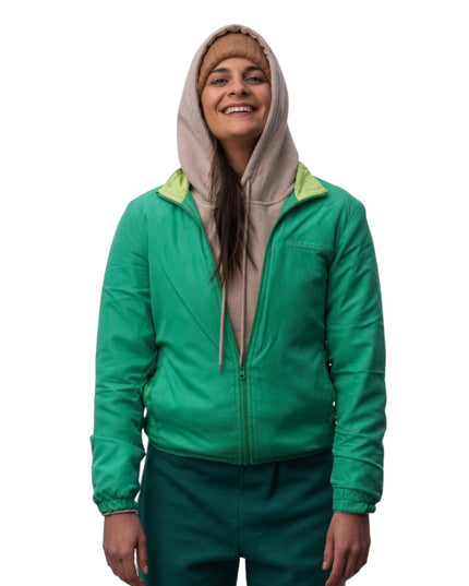 Person wearing a green jacket with a hood on a white background