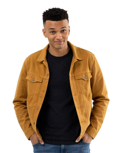 Man wearing a mustard yellow jacket over a black shirt on a white background