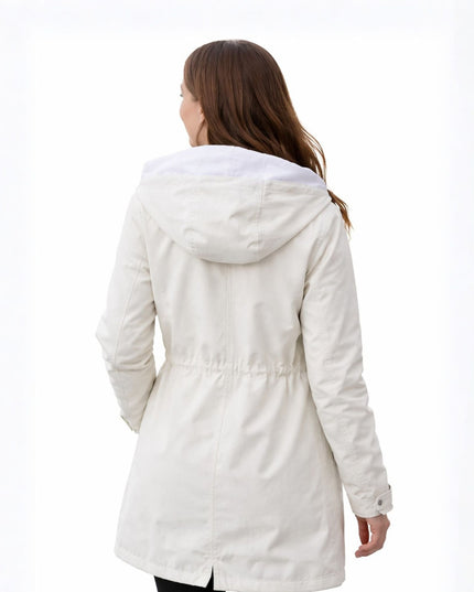 Woman wearing a white coat on a white background