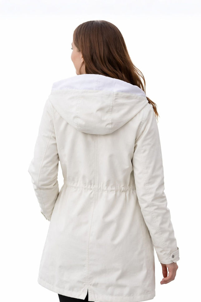 Woman wearing a white coat on a white background