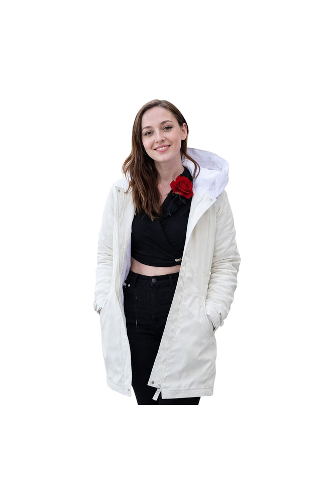 Woman wearing a white hooded jacket on a white background