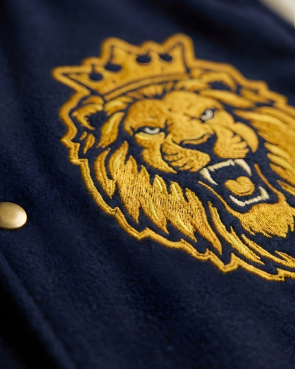 Embroidered lion design on a dark fabric background