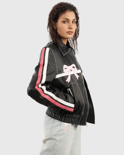 Person wearing a black jacket with pink and white accents on a light gray background