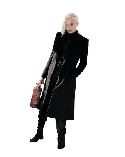 Person wearing a long black coat holding a red gas canister on a white background