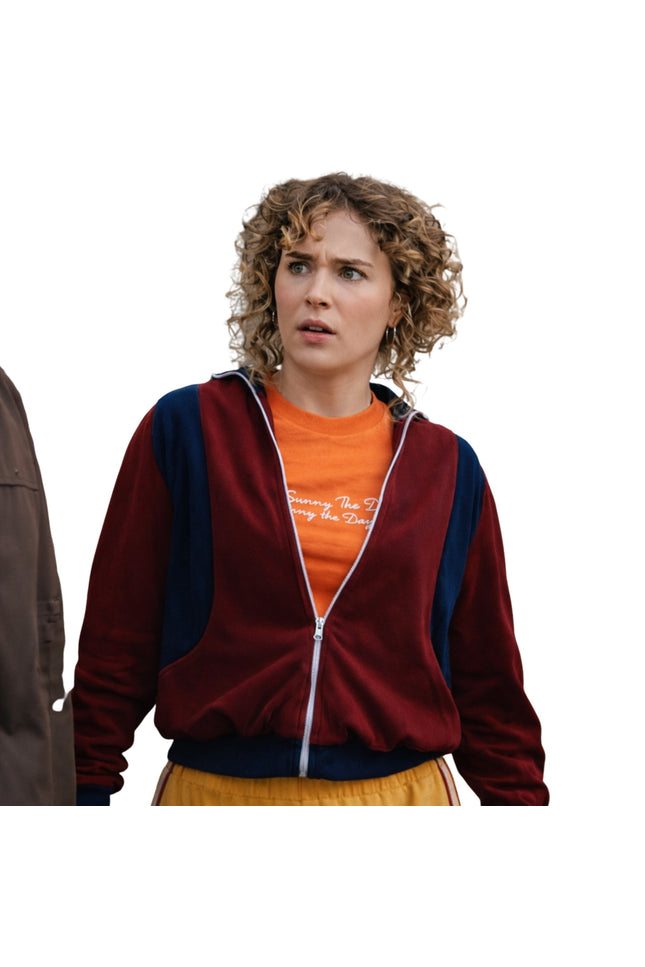 Person wearing a red and blue jacket over an orange shirt with text, on a white background