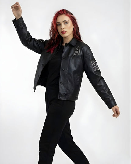 Person wearing a black leather jacket with lettering on a white background