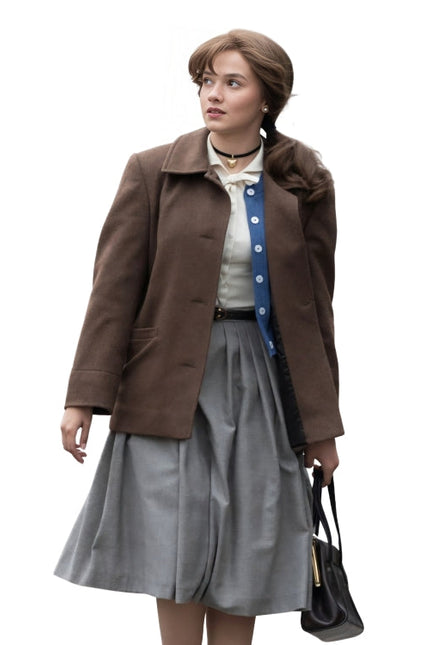 Woman wearing a brown leather jacket holding a gun on a white background