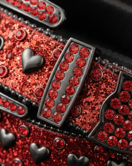 Close-up of a red glittery belt with black heart designs and red gemstones.