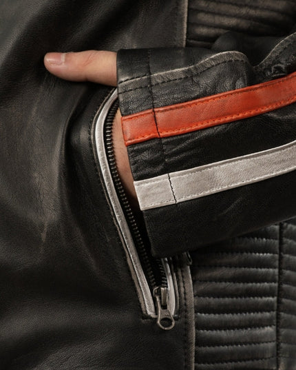Close-up of a person wearing a black leather jacket with a zipper detail.