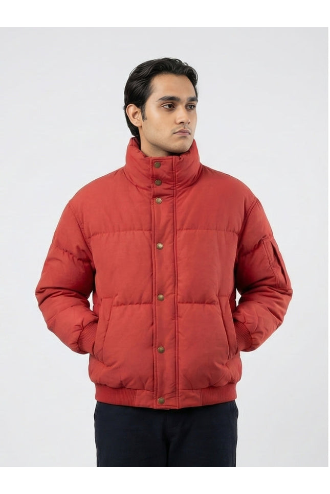 Man wearing a red puffer jacket on a white background