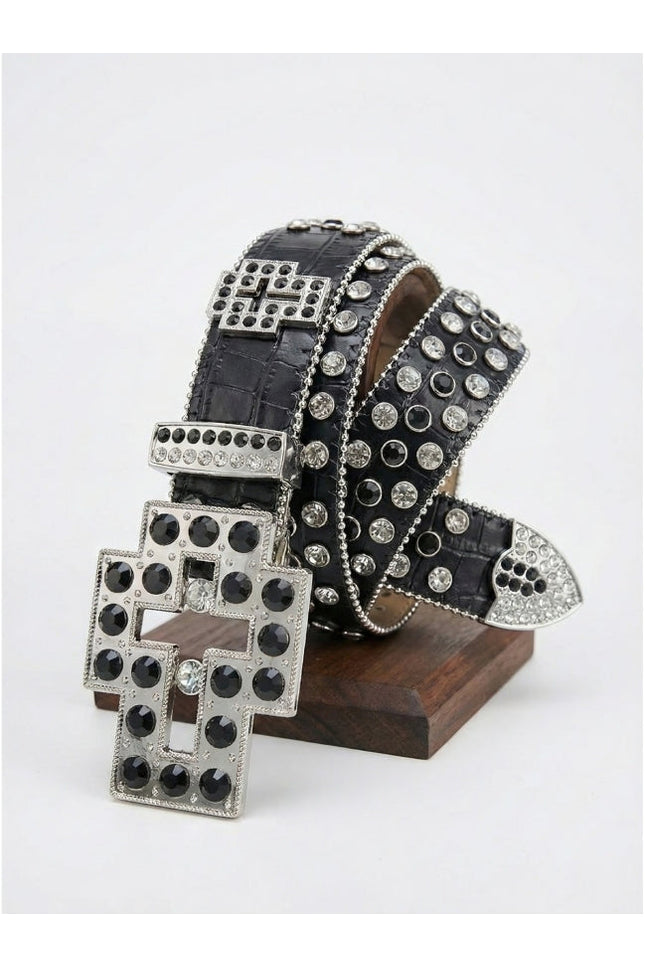 Black belt with silver studs on a wooden stand against a white background