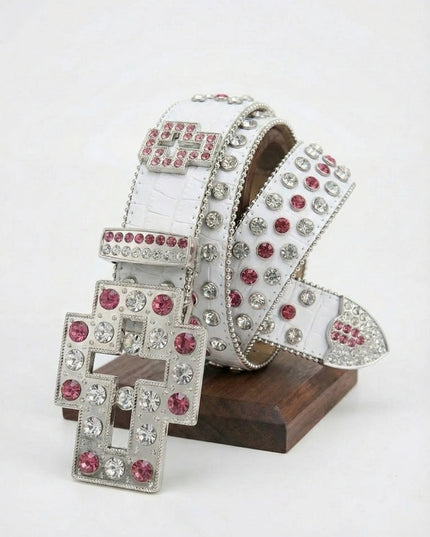 White belt with silver and pink gemstones on a wooden stand against a white background