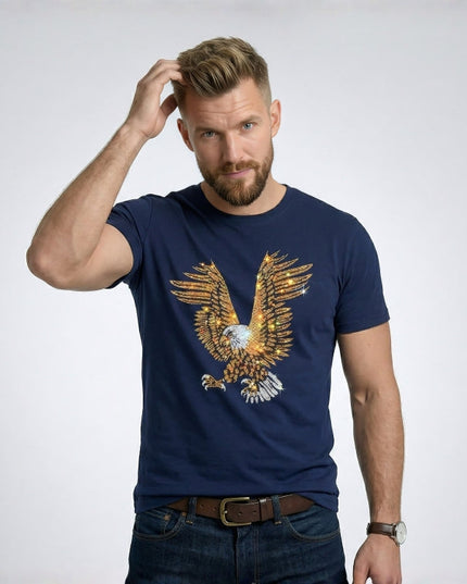 Man wearing a navy blue t-shirt with an eagle design on a plain background