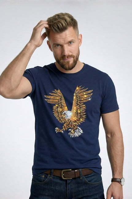 Man wearing a navy blue t-shirt with an eagle design on a plain background