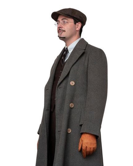 Man wearing a long gray coat, brown hat, and gloves on a white background