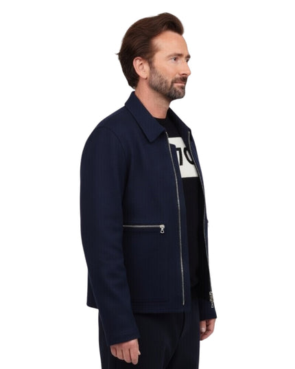 Man wearing a navy jacket with a white logo on a white background