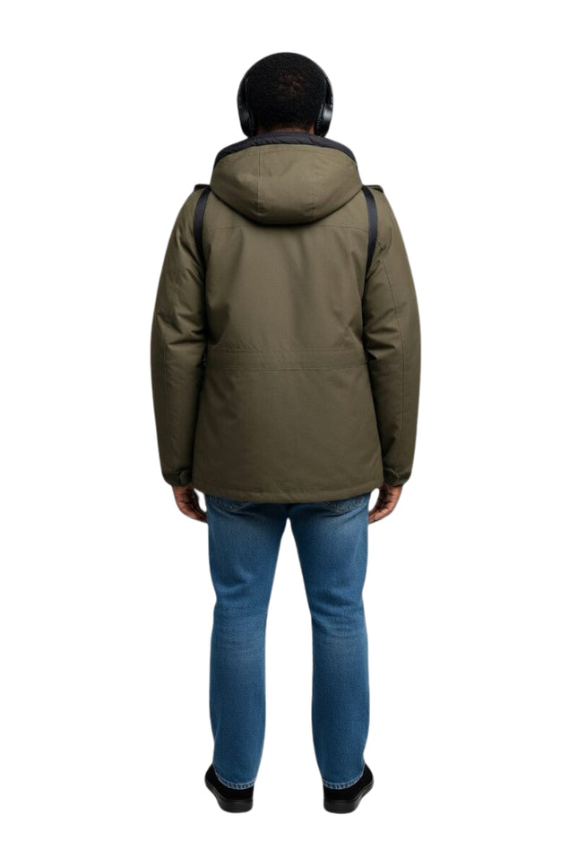 Person wearing a green jacket and blue jeans on a white background