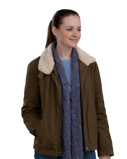 Woman wearing a brown jacket with a fur-lined hood and a blue scarf on a white background