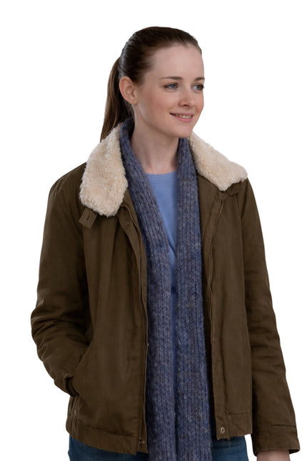 Woman wearing a brown jacket with a fur-lined hood and a blue scarf on a white background