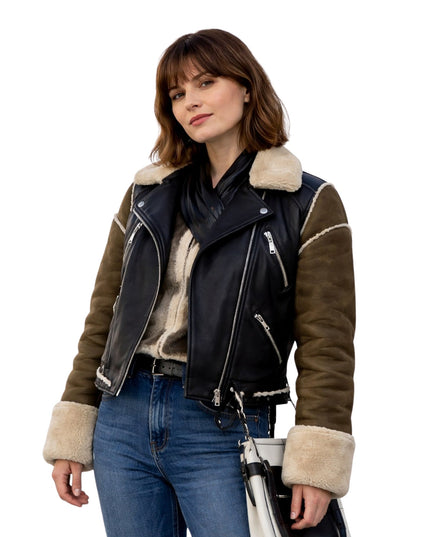 Woman wearing a black and brown leather jacket with fur trim on a white background