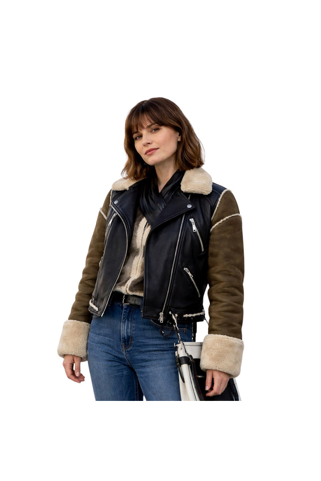 Woman wearing a black and brown leather jacket with fur trim on a white background