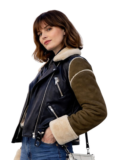 Woman wearing a black and brown jacket with white lining on a white background
