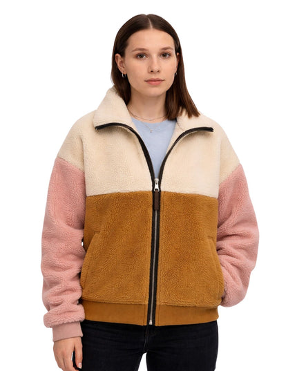 Woman wearing a multicolored fleece jacket on a white background