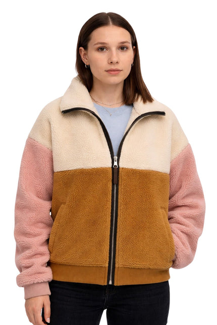Woman wearing a multicolored fleece jacket on a white background