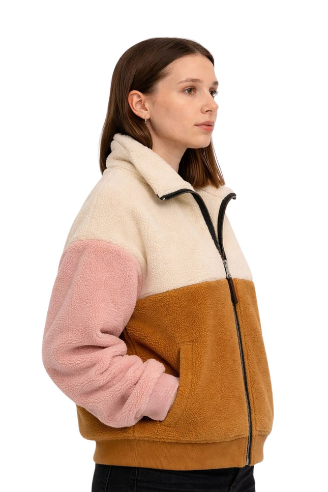 Woman wearing a color-blocked fleece jacket with beige, pink, and brown sections on a white background.