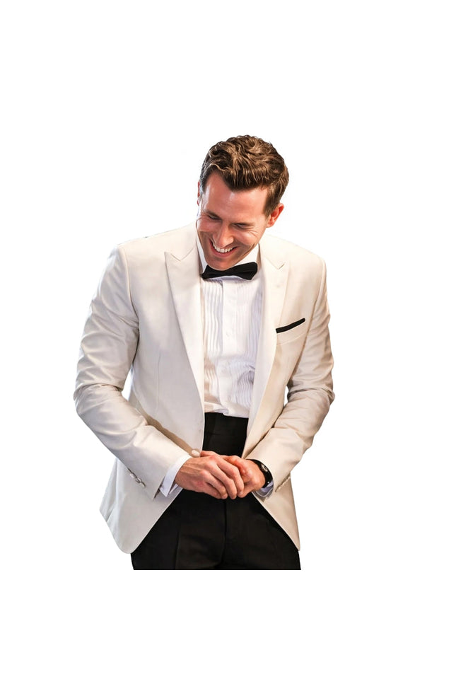 Man in a white tuxedo with a black bow tie on a white background
