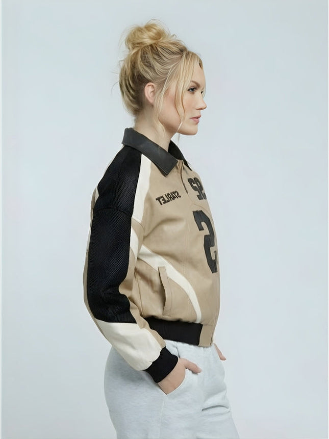 Woman wearing a black, beige, and white jacket on a light gray background