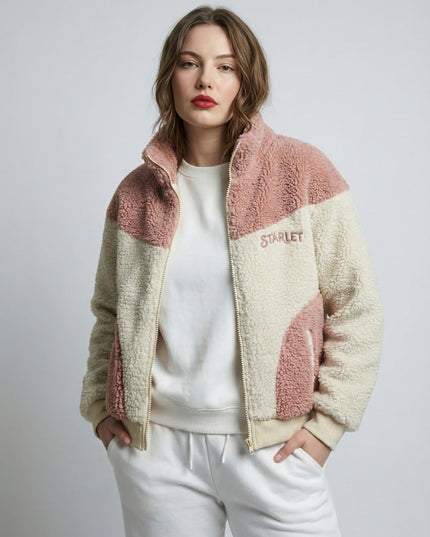 Woman wearing a two-tone fleece jacket with 'Starlet' branding on a plain background