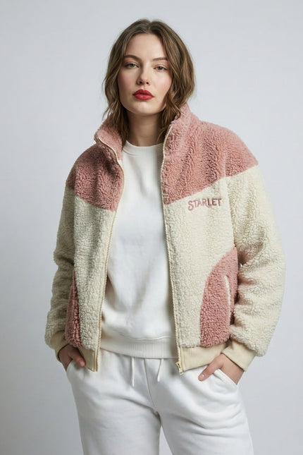 Woman wearing a two-tone fleece jacket with 'Starlet' branding on a plain background