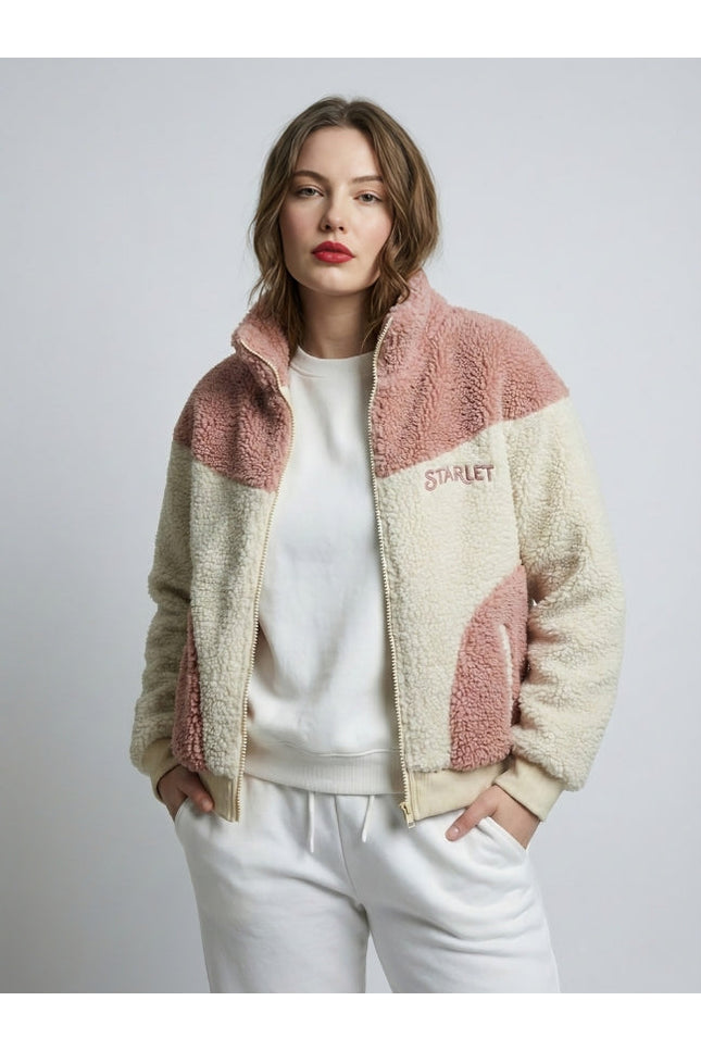 Woman wearing a two-tone fleece jacket with 'Starlet' branding on a plain background